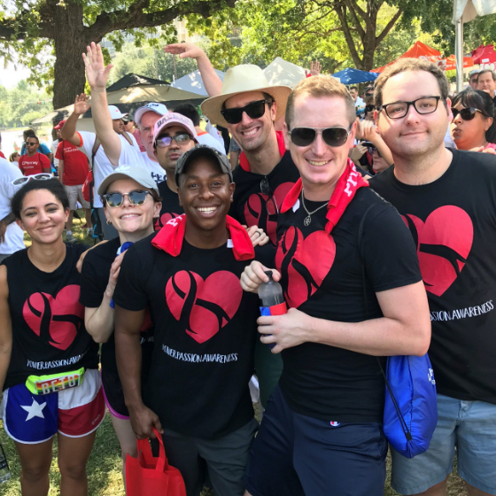 A group of men and women wave during the AIDS LifeWalk