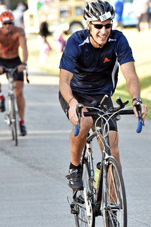 Jim Noble rides a bicycle during a triathlon