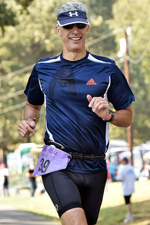 Jim Noble runs during a triathlon