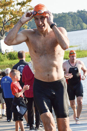 Jim Noble completes the swimming portion of a triathlon