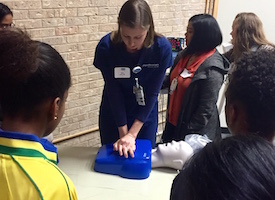 Students watch a CPR demo.