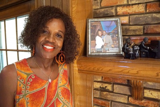 Phyllis Jefferson, standing beside a photo of her late husband, Theodore Jefferson Jr.