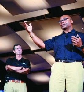 Dr. Hunt Batjer (left), Chair of Neurological Surgery and co-leader of UT Southwestern’s Texas Institute for Brain Injury and Repair, listened as former NFL coach and Hall of Fame linebacker Mike Singletary spoke during a concussion presentation to about 500 youth football coaches in July 2015.