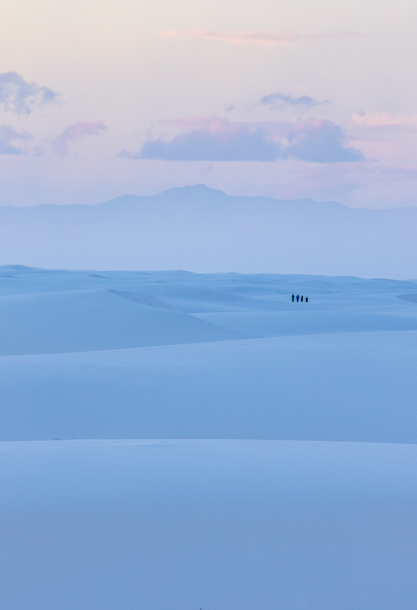 Dessert landscape with 4 people walking in the distance