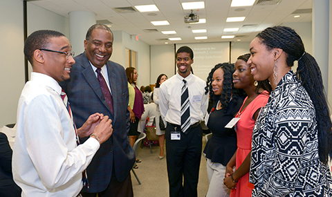 State Sen. Royce West (second from left) visits with college students taking part in the Dr. Emmett J. Conrad Leadership Program this summer.