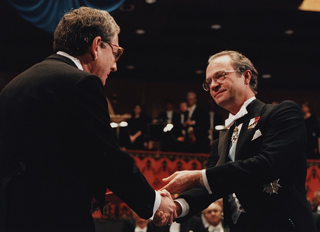 The King of Sweden, Carl XVI Gustaf (right), congratulates Dr. Alfred G. Gilman at the Nobel Prize ceremony in 1994