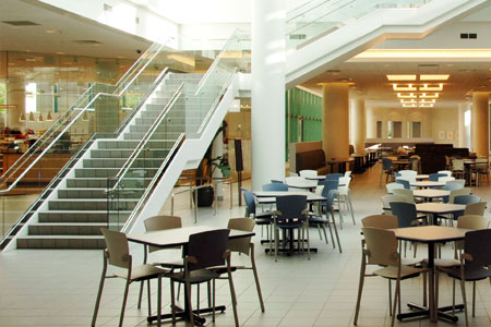Tables, chairs, and a staircase in a North Campus dining area