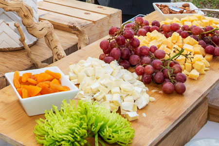 A tray with plates of fresh fruit and vegetables