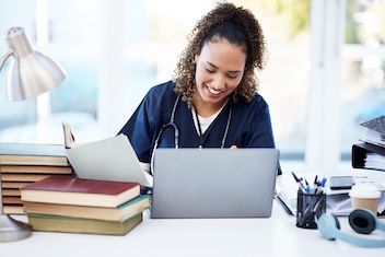 woman in medica uniform at computer