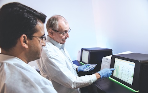 Dr. Prithvi Raj (left) and Dr. Edward Wakeland examine DNA sequencing data