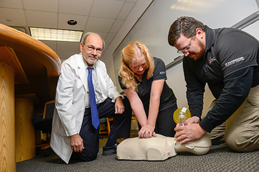 Ahamed Idris, M.D., consults with Emergency Medical Technicians Pam Owens and Tom Cooper