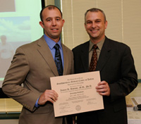 Dr. Steven Vernino presents award to Dr. James Battiste