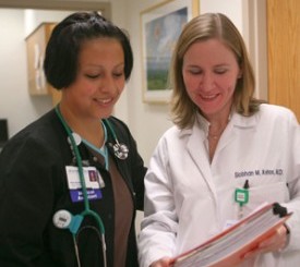 Dr. Siobhan Kehoe speaks with a nurse.