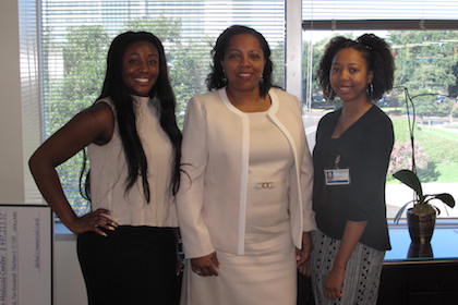 Assistant Vice President for Diversity & Inclusion and Equal Opportunity Kimel Hodges (center) congratulates Conrad program interns Leah Levels (left) and Rachel Maxie.