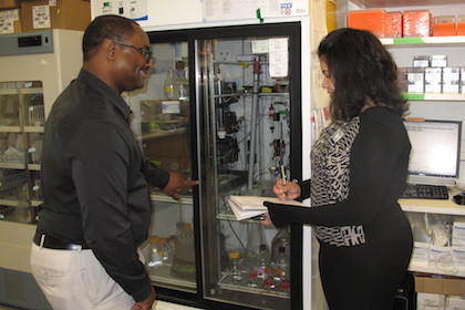 Technical Support Supervisor Carl Campbell shows intern Aileen Mendez how to do inventory at one of the Department of Biophysics’ labs.