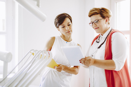 Two female doctors reading chart