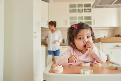 A little girl in a high chair