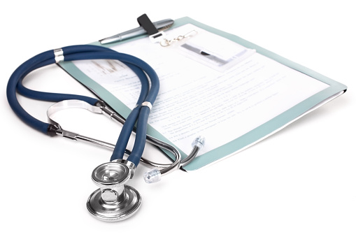 Image of a stethoscope lying beside a patient chart