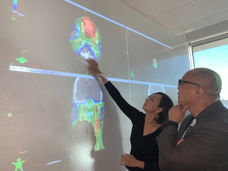 Dr. Mu-Han Lin, left, consults with Dr. Steve Jiang about a radiation treatment plan developed by artificial intelligence