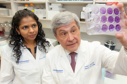Drs. Carlos Arteaga and Dhivya Sudhan look at slides