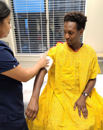 Nurse taking blood pressure on a patient's right arm