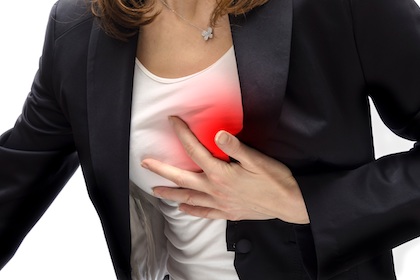 A woman clutching her chest that has a red image on it
