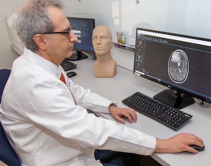 Dr. Joseph Maldjian examines imaging of a brain tumor