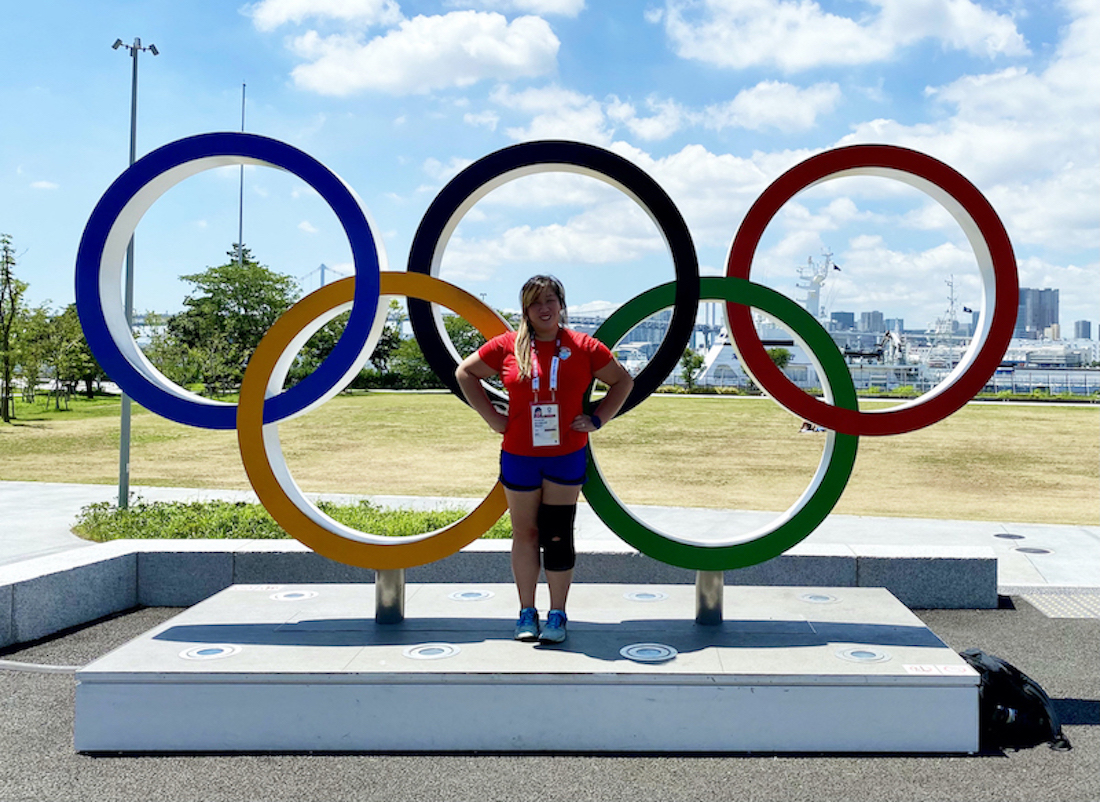 Dr. Stephanie Tow, M.D., standing in front of Olympics rings