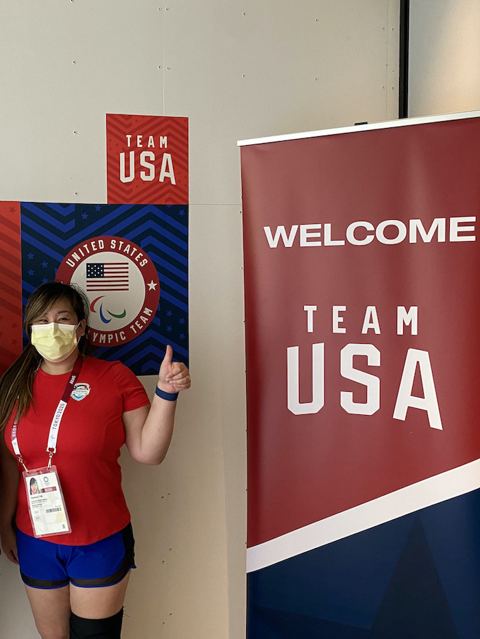 Dr. Stephanie Tow, M.D., standing in front of Olympics rings