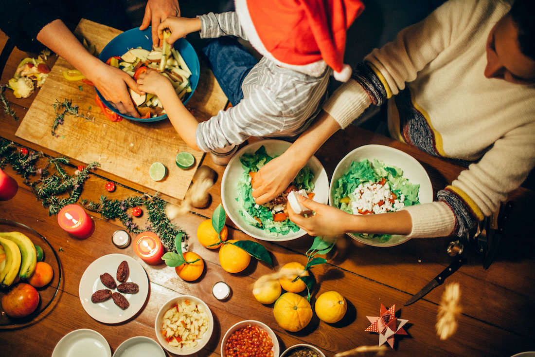 Two women preparing Christmas dinner with young boy