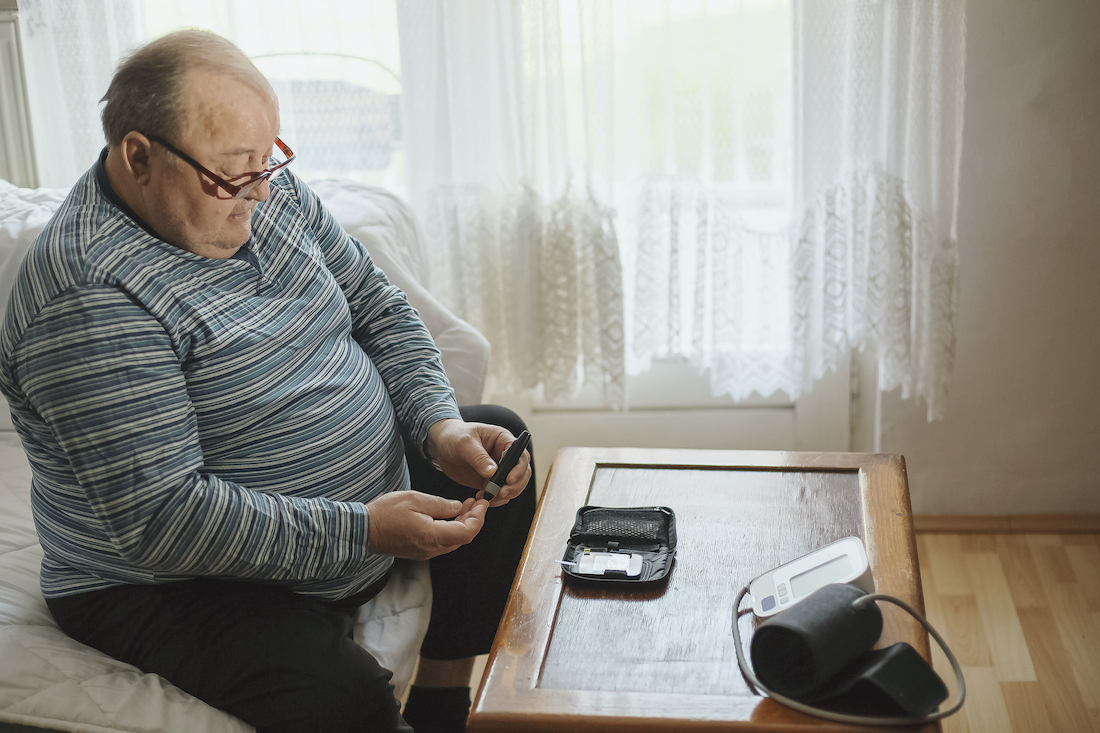 Senior man checking blood sugar levels