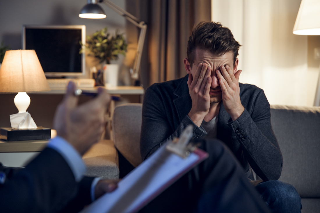 Senior psychologist interviewing his depressed patient. Mental therapy.