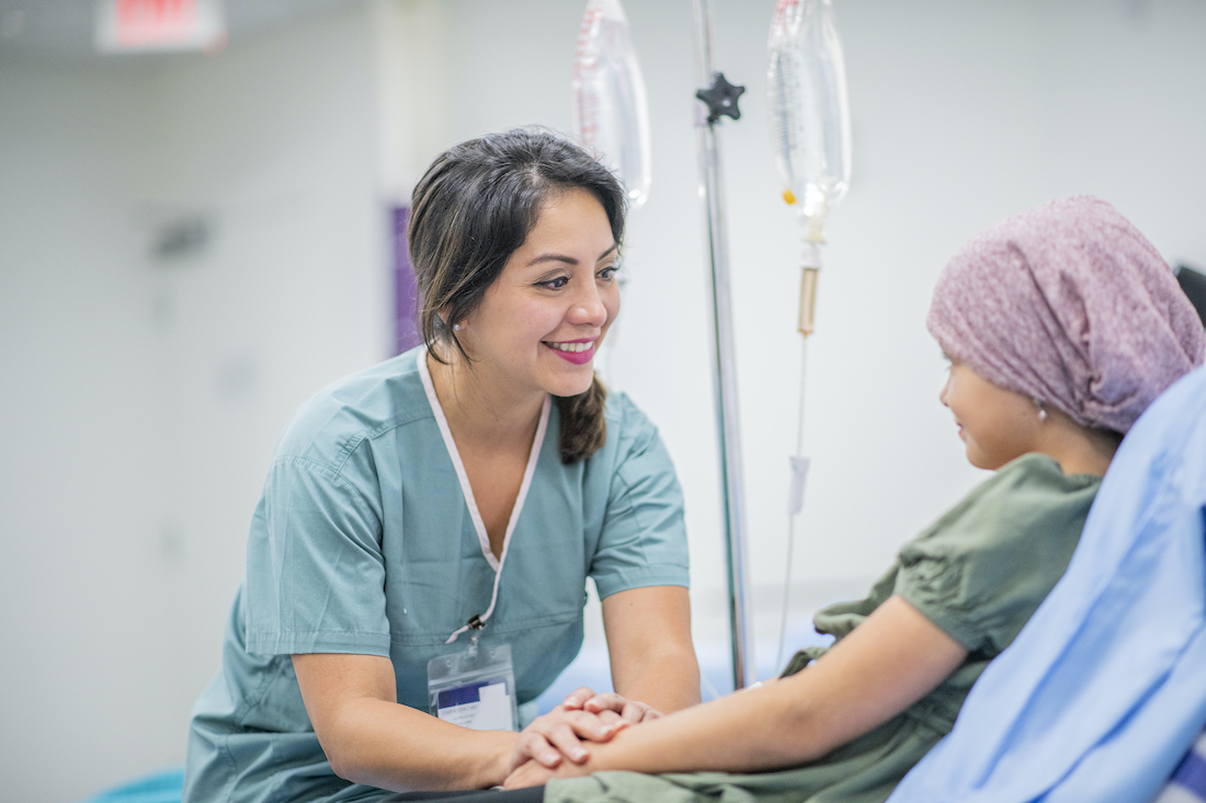 A little girl with Cancer is visited by her Doctor to check on her intravenous drip treatment