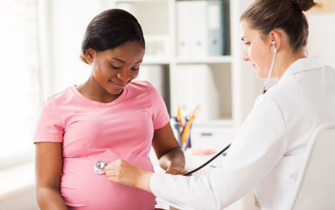 pregnant patient receiving prenatal care from a doctor