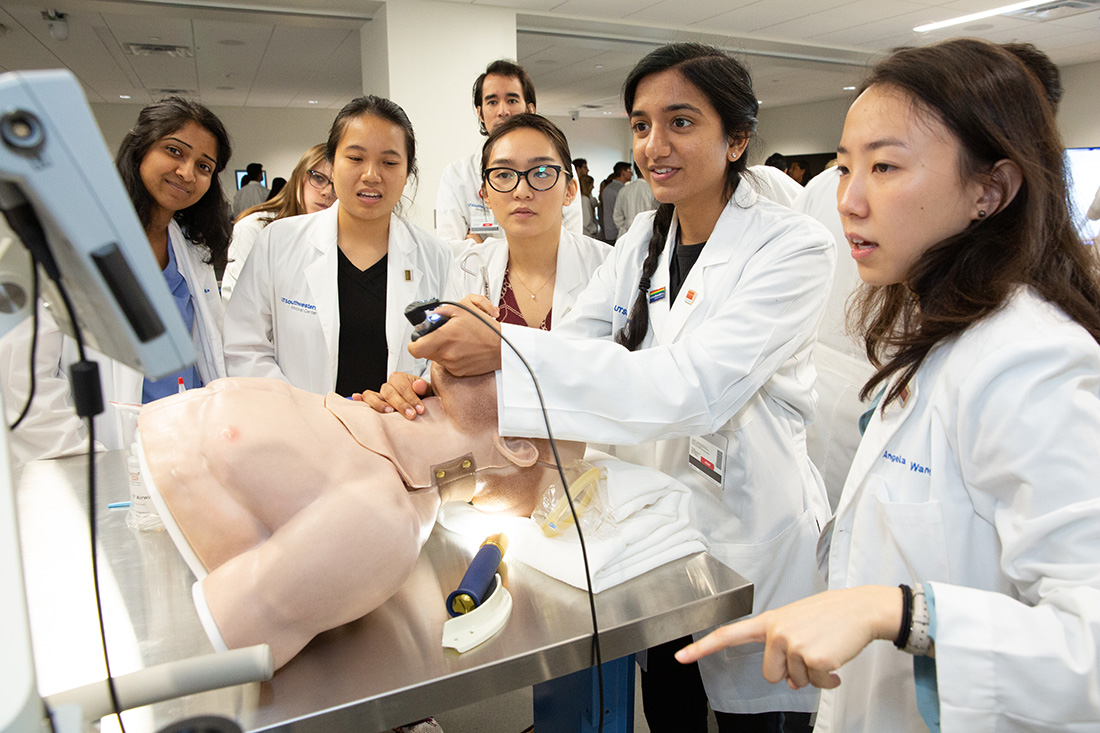 Simulation center students practicing a procedure on a manikin