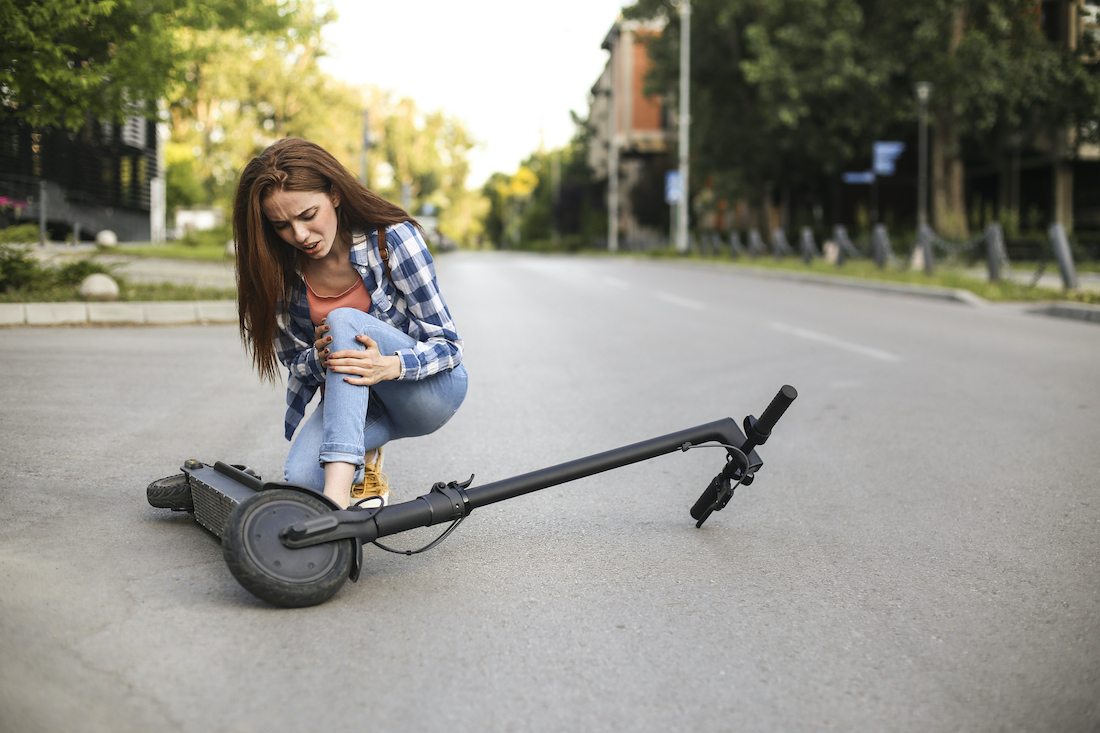 Young woman injured while driving an electric scooter in the city.