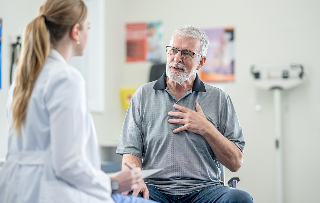 Male patient in exam room speaking with female physician