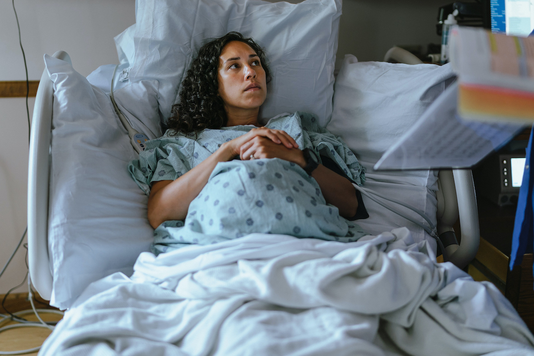 Pregnant woman in labor at the hospital speaking with a doctor