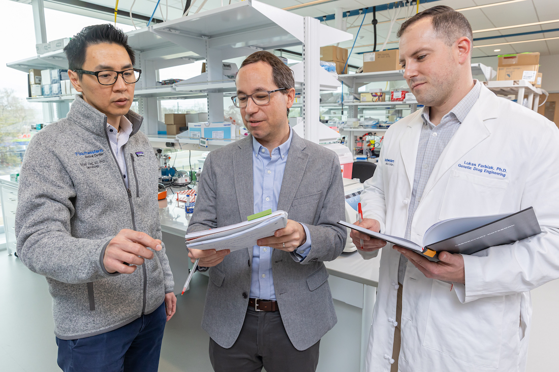 Richard C. Wang, M.D., Ph.D., (left) talks with Daniel Siegwart, Ph.D., (center) and Lukas Farbiak, Ph.D., (right) about their research