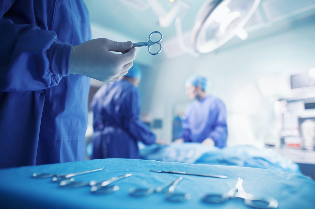 Doctors performing surgery in hospital operating room