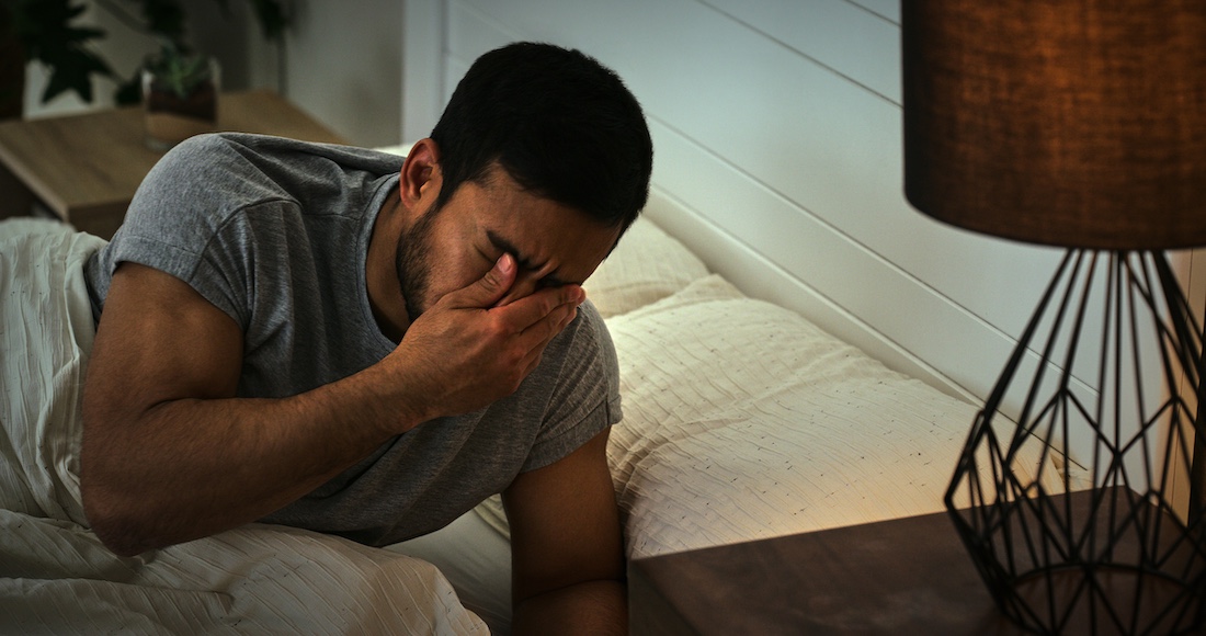 Fatigue, conflict and male person in a bedroom with overthinking stress, nightmare or mistake trauma at home