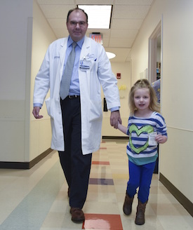 Dr. Juan Pascual walking with Anna Gunby
