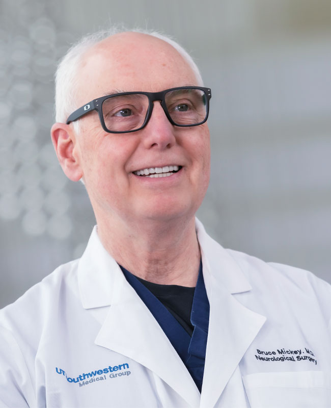 Photo of Dr. Bruce Mickey a man wearing glasses and lab coat
