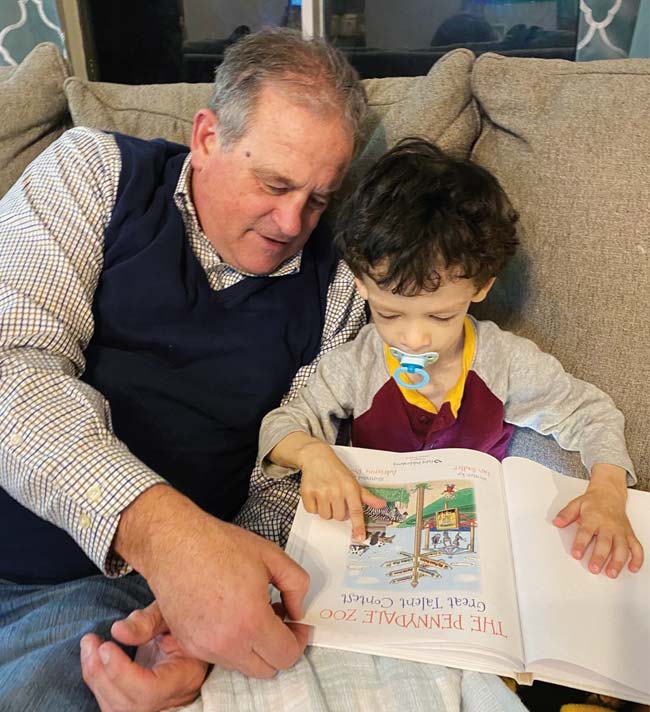 A man reading with a little boy