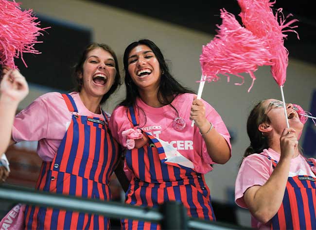 UT Arlington volleyball fans wave pink pom-poms