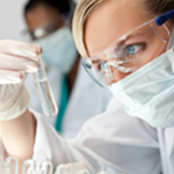 A doctor performing a test for ricina inside of a test tube