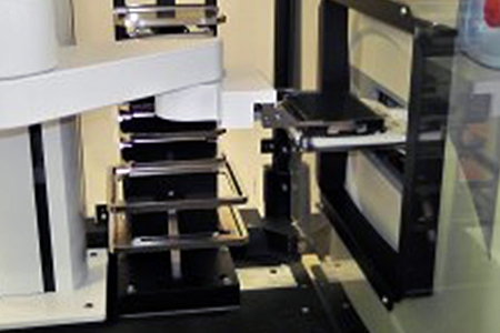 The robotic arm of the Access platform passes a 384-well plate to the Echo 555 acoustic dispenser for a dose-response experiment. The Echo 555 uses sound to dispense 2.5-nL droplets of compound into assay plates.