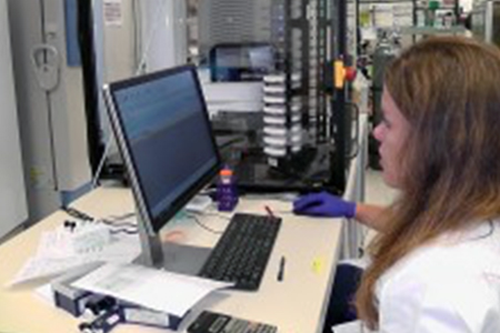 Screening scientist Melissa McCoy, Ph.D., oversees the Echo 555 liquid handler and the automation that supports plate handling.