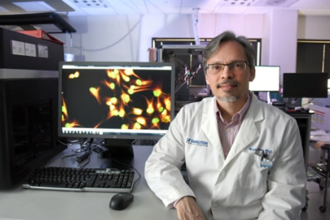 Image of Dr. Posner seated at desk in lab