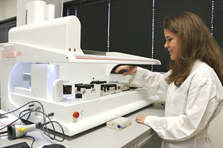 Screening scientist Melissa McCoy uses the XL100 to transfer stock solutions of small molecules from 1-dram amber vials to 2D-barcoded tubes.